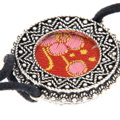 Silver filigree bracelet with red brocade