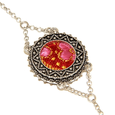 Silver filigree bracelet with red brocade