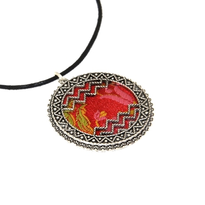 Silver filigree pendant with red brocade