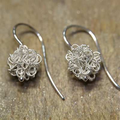 Silver earrings with filigree flocks.
