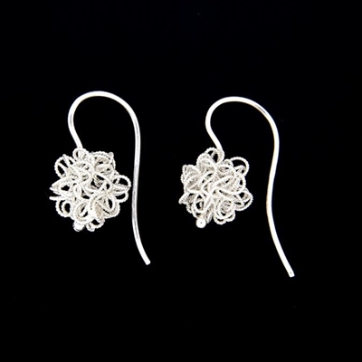 Silver earrings with filigree flocks.